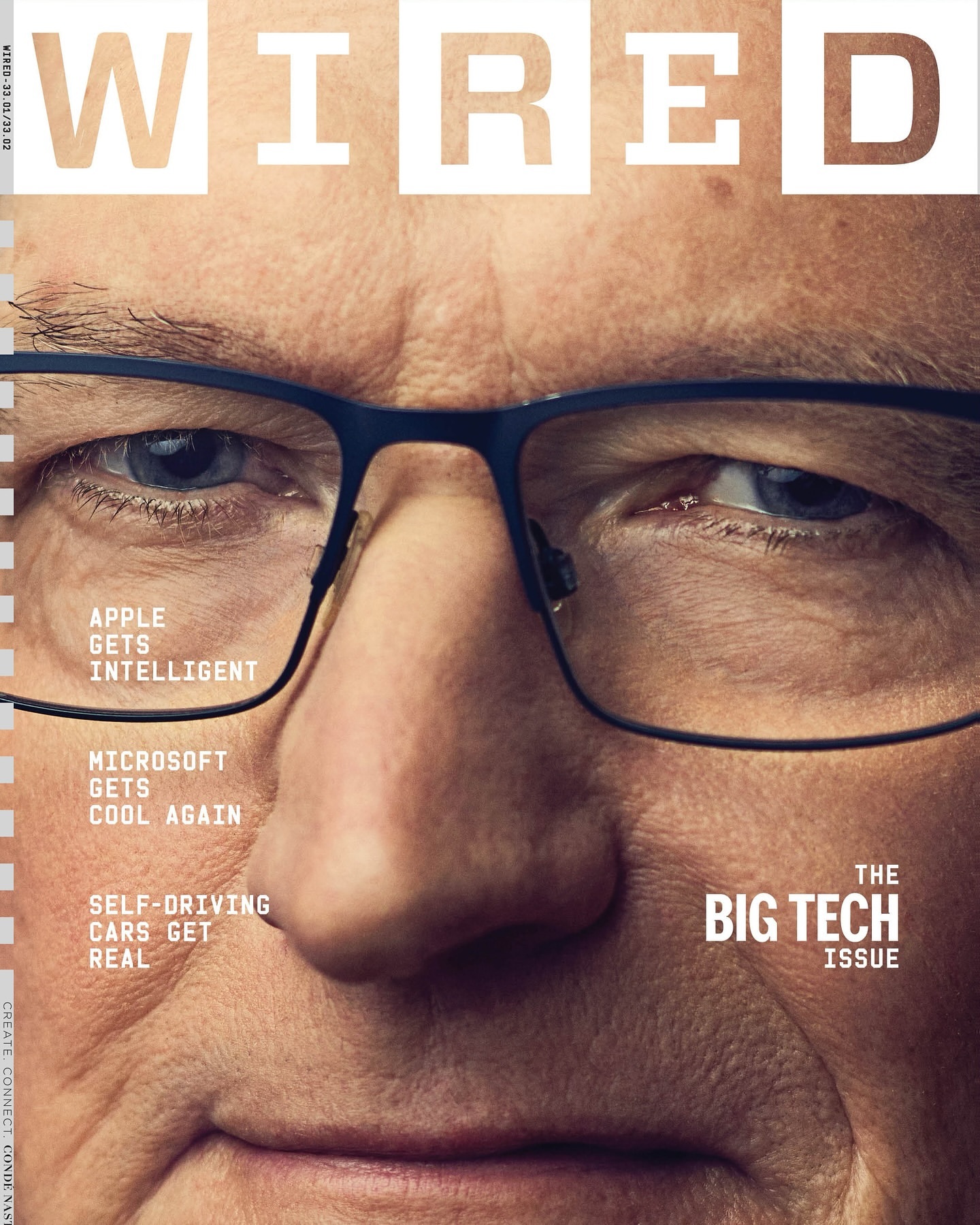 Close-up of an adult male with glasses on a magazine cover for WIRED, featuring headlines about Apple, Microsoft, and self-driving cars.
