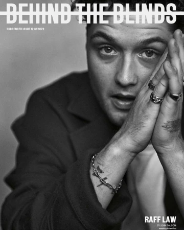 Black and white portrait of Raff Law on Surrender magazine cover, issue 12, with hands near face, rings, and bracelet.
