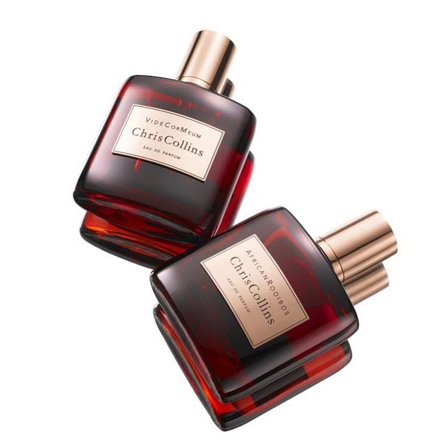Two bottles of Chris Collins Eau de Parfum, one named Vide Cor Meum and the other African Rooibos, on a white background.