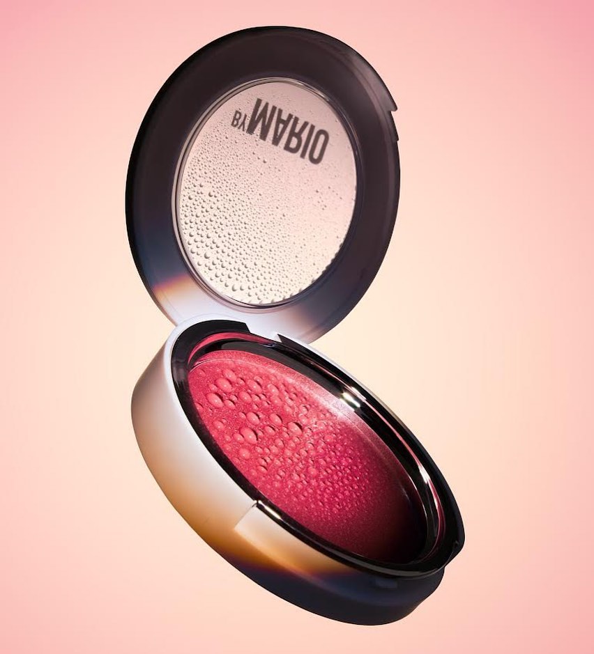 Macro studio shot of blush compact. The makeup case is open, displaying the product. Pink gradient background. Beauty, cosmetic product photography.