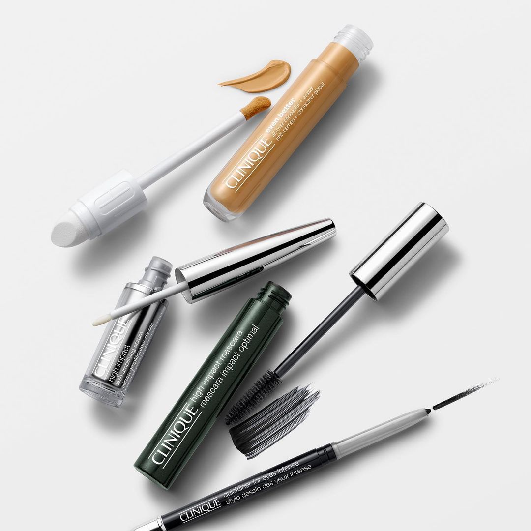 Clinique makeup set against white background with mascara, eyeliner, and concealer; a focus on product presentation and beauty.