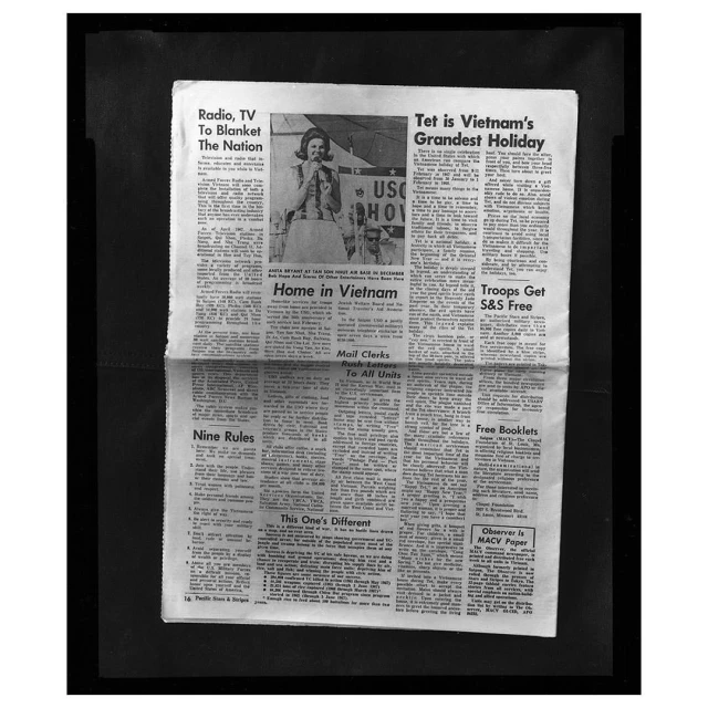 Vintage newspaper with headlines, articles, and an image of a smiling woman and a 'USO' sign, evoking a sense of history and place.