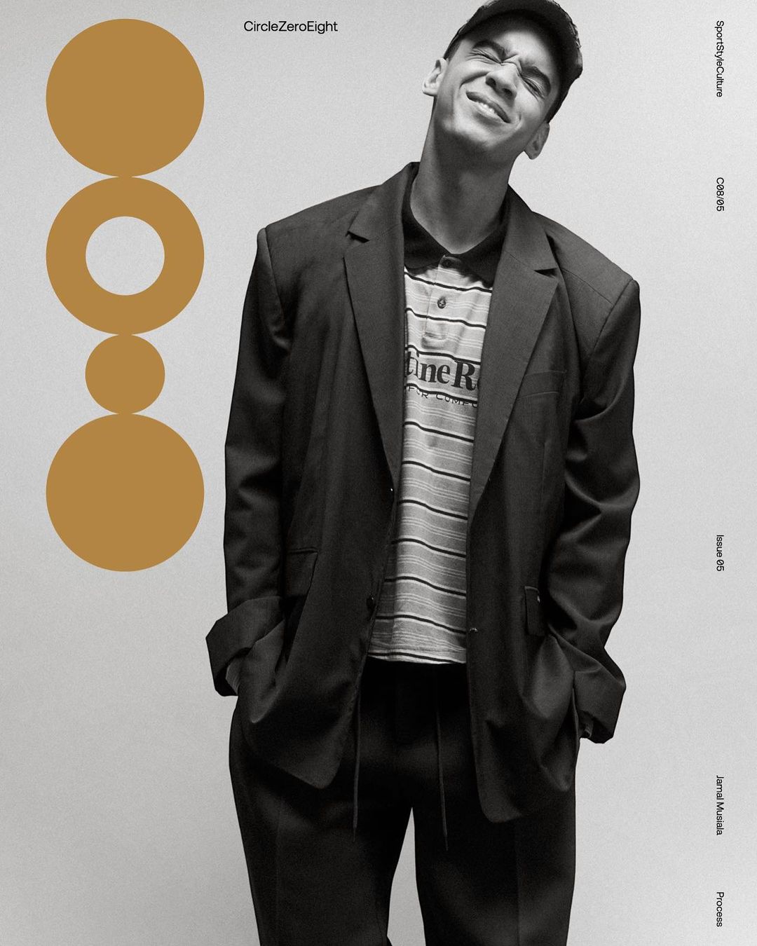 Young adult wearing a black blazer and baseball cap smiles slightly, posing against a light background with ochre graphic elements.
