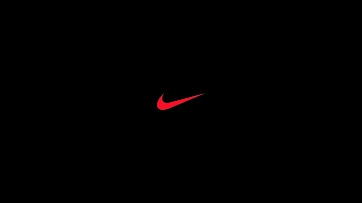 Nike swoosh logo displayed in red against a black background, iconic symbol of athletic apparel and brand recognition.