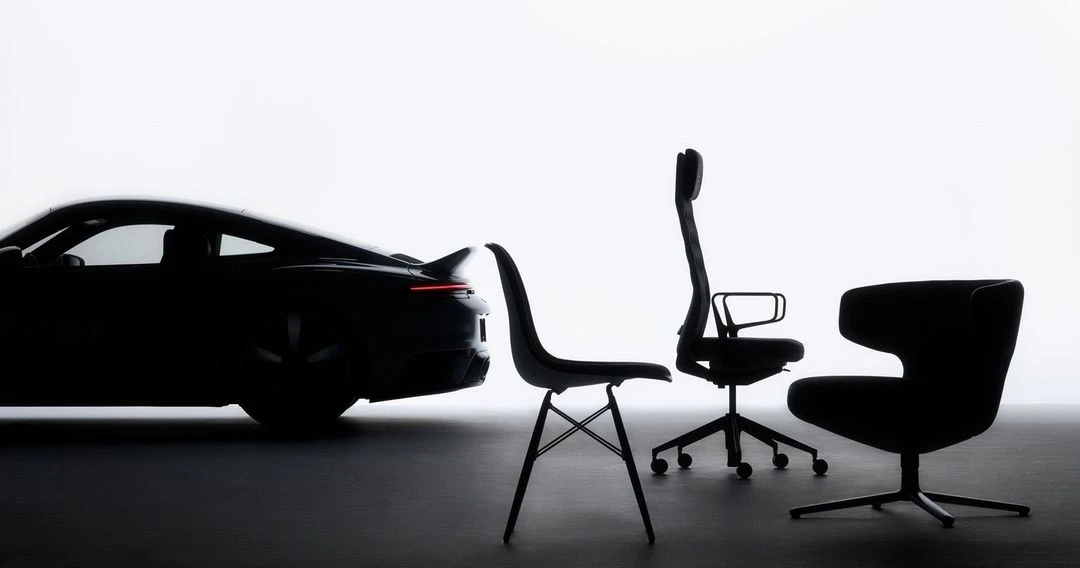 Silhouette of a modern black Porsche car positioned alongside three contemporary black office chairs against a bright, minimalist backdrop.