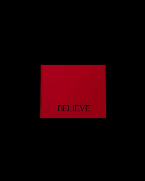 A red square centered on a black background has the word “BELIEVE” in a smaller, dark font at the center of the red shape.