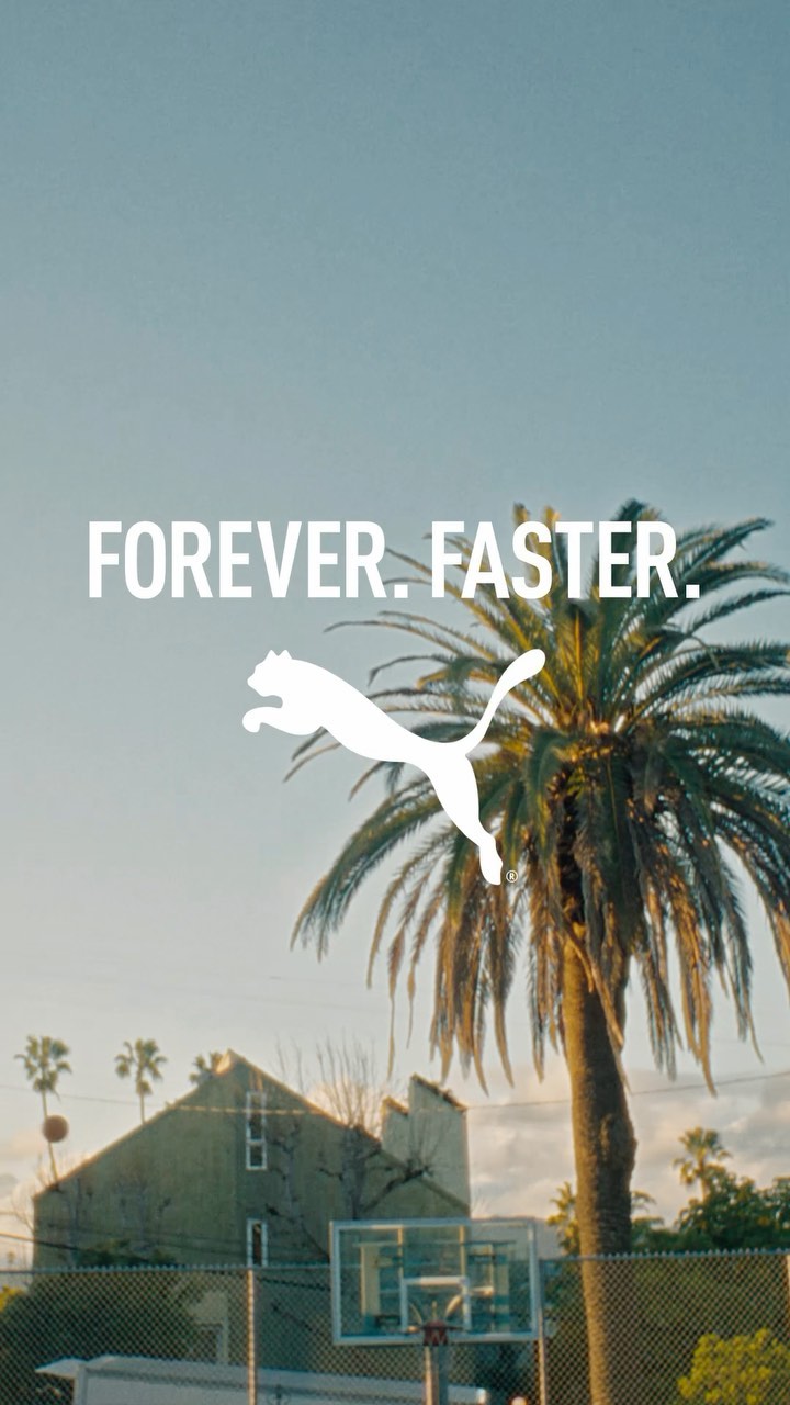 Puma logo and text 'Forever Faster' against a blue sky with a palm tree and a basketball hoop in the background. Outdoor setting.