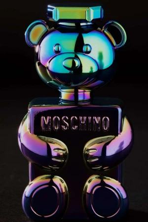 Moschino Toy 2 Bubble Gum perfume bottle, shaped like a teddy bear, features an iridescent color scheme on a dark background.