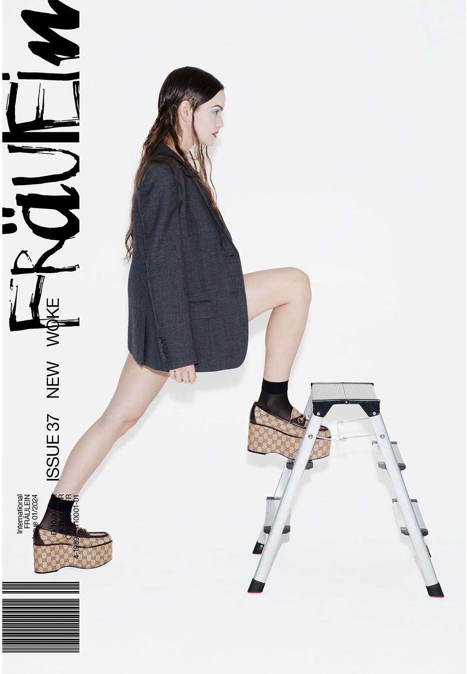Editorial fashion shot featuring a young woman in an oversized blazer and platform shoes, posing with a step stool against a white background.