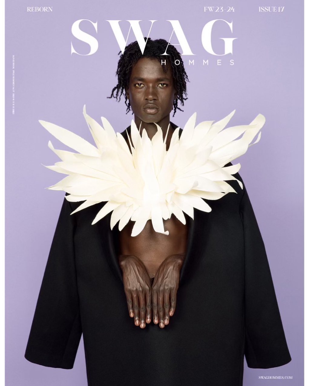 Editorial fashion shot of a Black man in a black coat and ornate white collar against a light purple background for SWAG Hommes magazine.