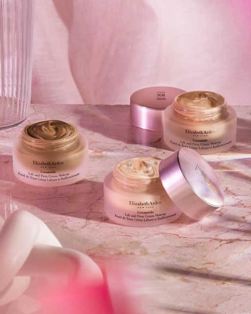 Elizabeth Arden Ceramide makeup: luxurious skincare-infused foundation on a pink marble surface, soft lighting, and elegant aesthetic.
