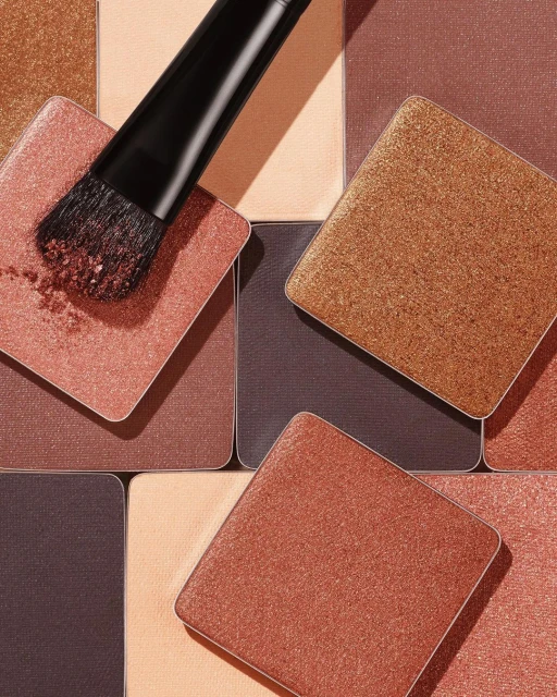 Square eye shadow palette with makeup brush applicator, close-up still life, beauty shot for cosmetic advertising and product display.