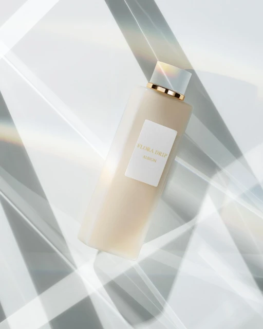 Still life product shot featuring a bottle of Flora Drip Elaskin skincare product, showcasing minimalist aesthetic and geometric light.