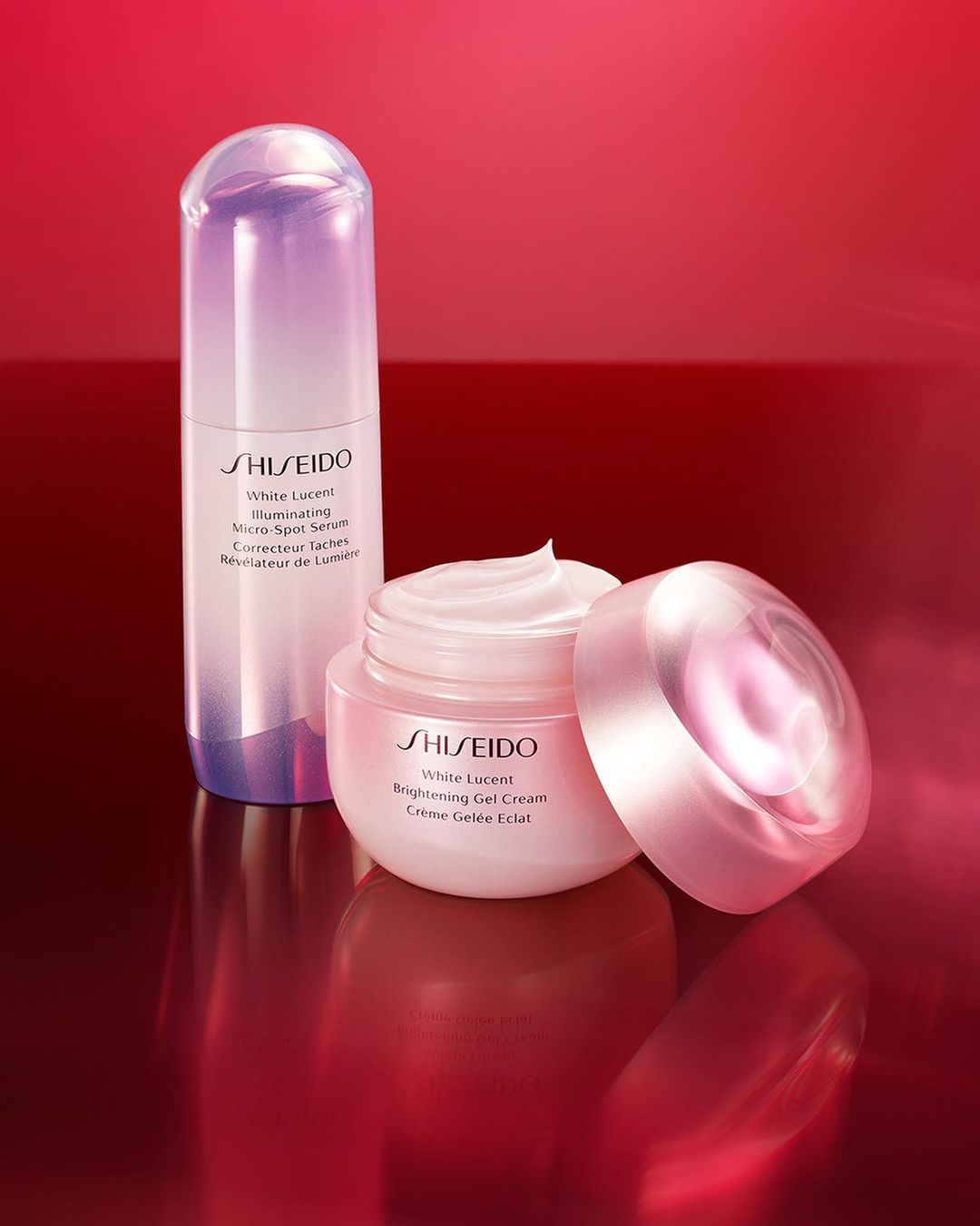 Shiseido White Lucent brightening skincare products on a reflective red gradient surface, highlighting cosmetics and beauty.