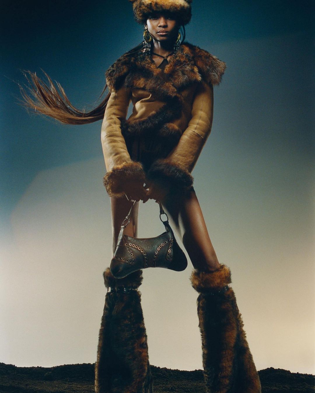A striking fashion shot features a Black woman modeling a fur-trimmed outfit, accessorized with earrings and a handbag against a gradient background.