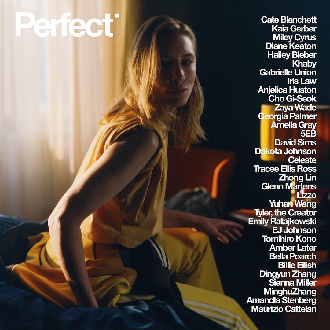 Blonde woman in yellow athleisure sits on a bed; a "Perfect" magazine cover featuring celebrities on the right side of the frame.