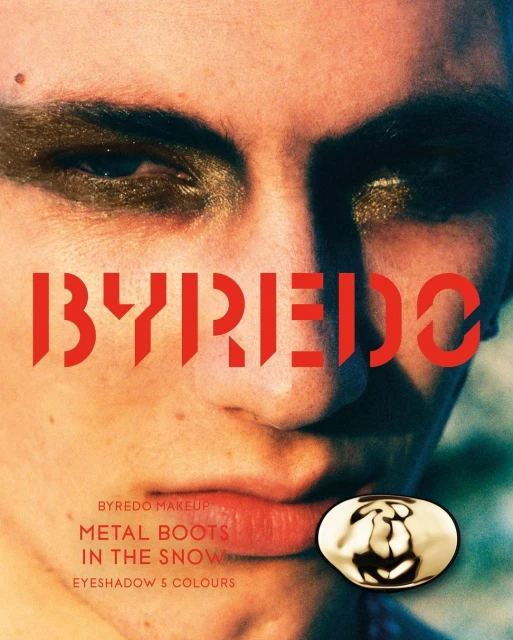 Close-up of a person's face with bold gold eyeshadow, accompanied by the logo and product name, "BYREDO METAL BOOTS IN THE SNOW."