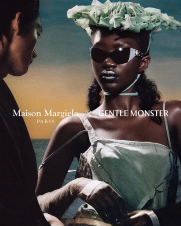 Eye-level shot of two models. A woman wears light-green clothing, sunglasses, and a sculptural hat. Text reads Maison Margiela x Gentle Monster.