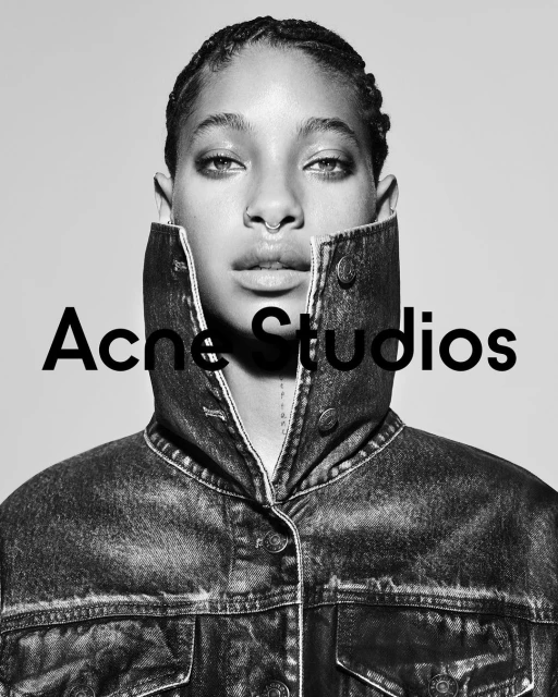 Black-and-white portrait of a woman in a denim jacket, facing forward against a neutral background, with the 'Acne Studios' logo.