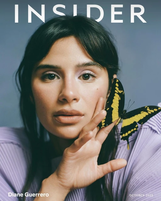 Magazine cover featuring Diane Guerrero, looking at the camera with a butterfly on her hand, against a solid blue background.