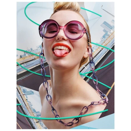 Woman wearing round purple sunglasses and matching chain strap sticking her tongue out in London by Joseph Ford.