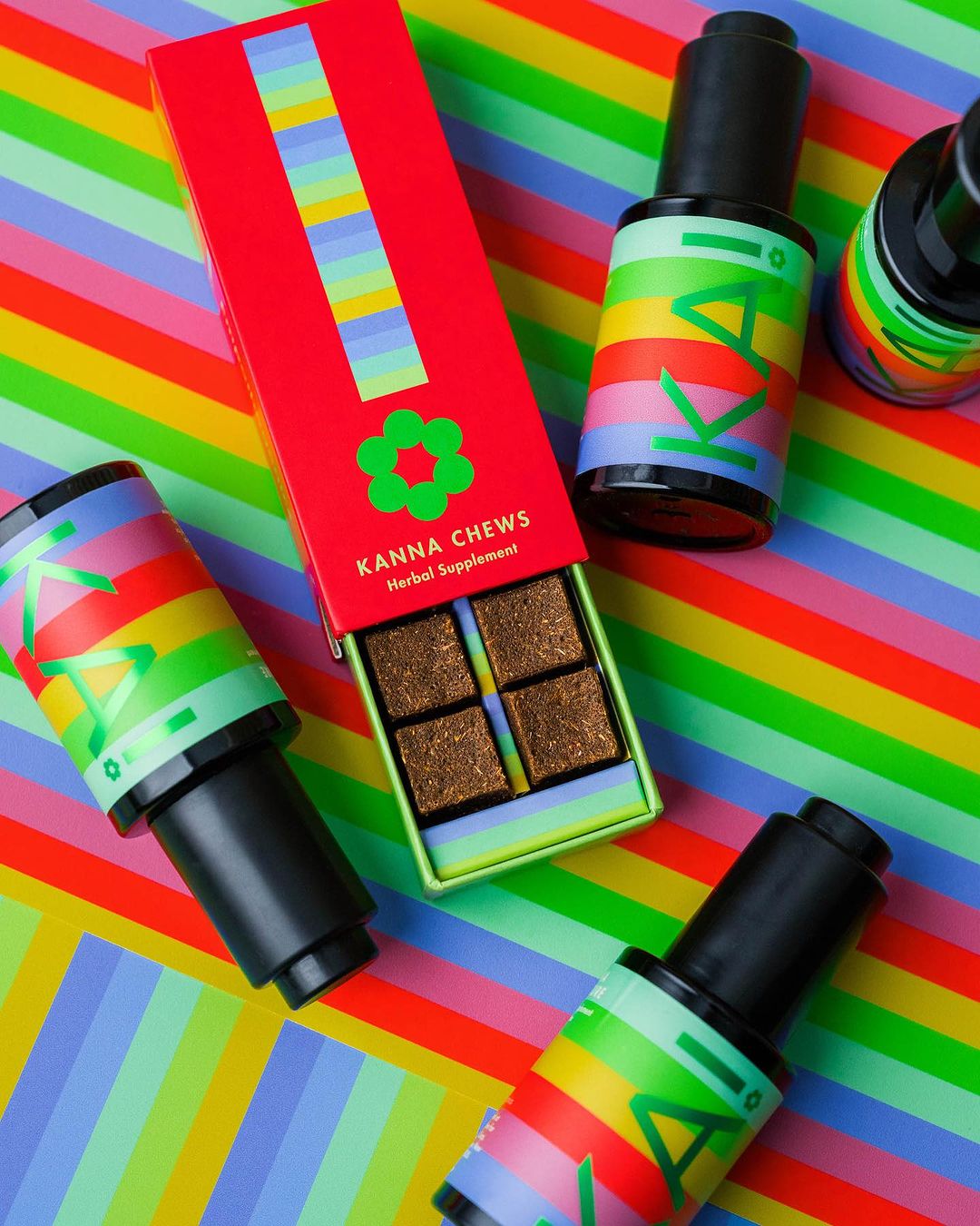 Kanna Chews herbal supplement box with colorful striped background, surrounded by dropper bottles with matching rainbow stripes.