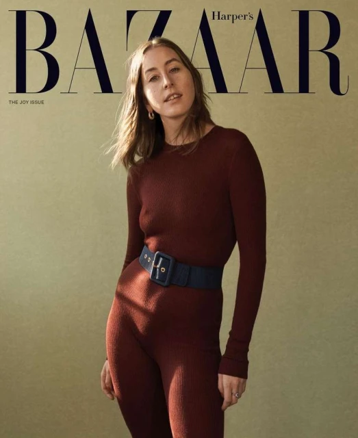 Magazine cover featuring a woman in a burgundy jumpsuit with a navy belt against a neutral background, with 'BAZAAR' prominently displayed.
