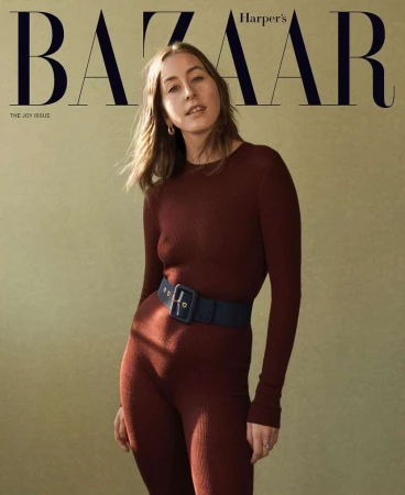 Magazine cover featuring a woman in a burgundy jumpsuit with a navy belt against a neutral background, with 'BAZAAR' prominently displayed.