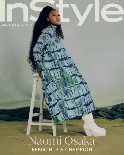 Naomi Osaka sits on a white stool wearing a green and navy tie-dye dress and white platform boots for a magazine cover.