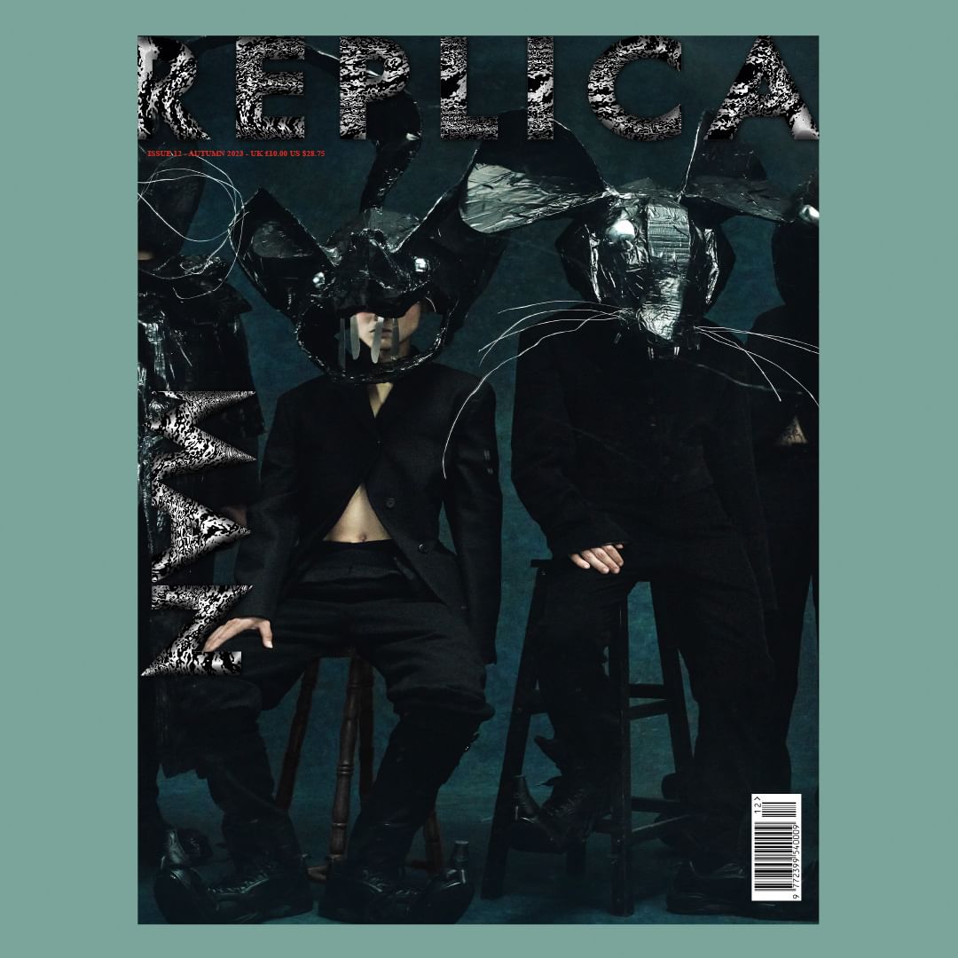 Fashion magazine cover featuring three figures wearing unconventional headgear, dark clothing, and dramatic makeup in a dark setting.