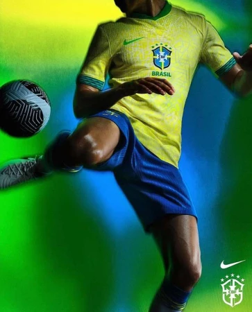A soccer player in a yellow and blue uniform kicks a soccer ball on a green and blue gradient backdrop with Nike and Brazil logos.