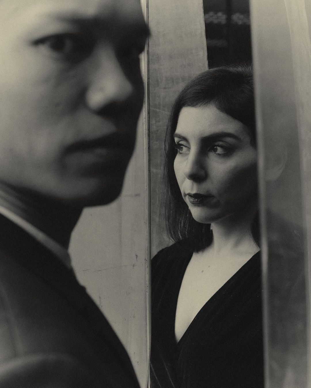 Portrait of an Asian man in the foreground and a woman looking away in a separate pane by photographer Joss Mckinley