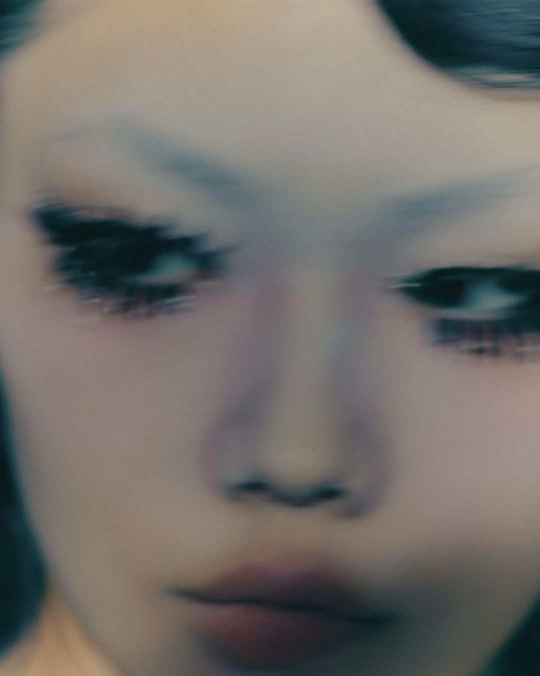 Close-up portrait of a person with dramatic eye makeup and motion blur captured by photographer Joss Mckinley