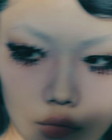 Close-up portrait of a person with dramatic eye makeup and motion blur captured by photographer Joss Mckinley