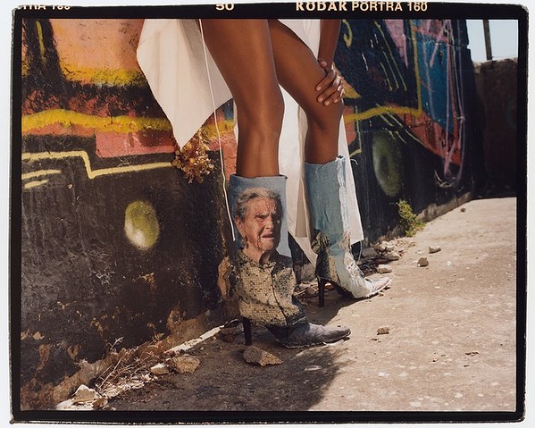 Model showcases custom denim heeled boots featuring a photo of a senior woman in a fashion-style shot with a graffiti wall backdrop.