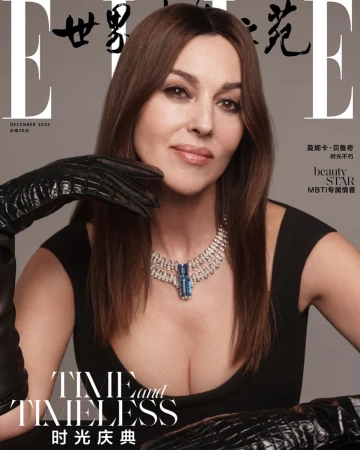 Monica Bellucci on the cover of Elle China December 2024 wearing a black dress and diamond jewelry, shot in a photo studio.