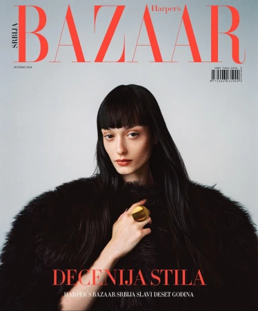 Harper's Bazaar Serbia cover featuring a woman with dark hair wearing a black fur coat and a gold ring, against a light gray backdrop.