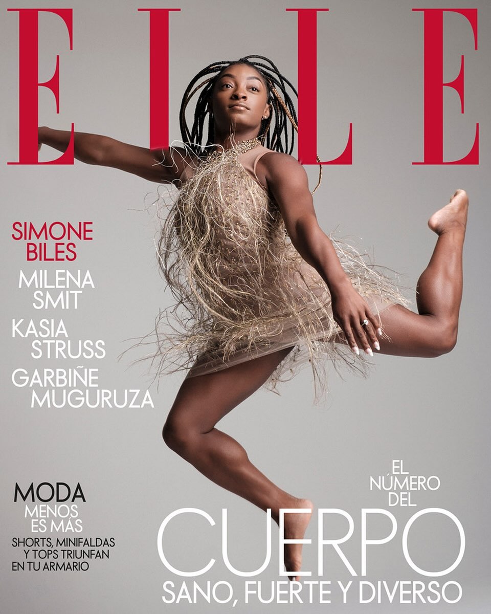 Elle Magazine cover featuring Simone Biles in mid-air wearing a fringed dress against a grey background with red magazine text.