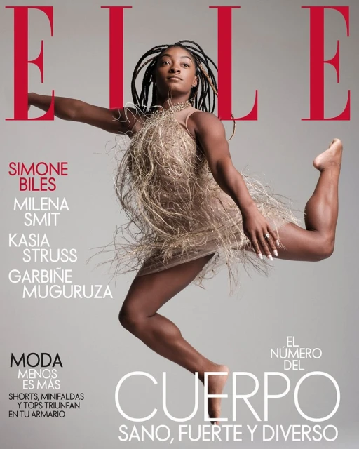Elle Magazine cover featuring Simone Biles in mid-air wearing a fringed dress against a grey background with red magazine text.