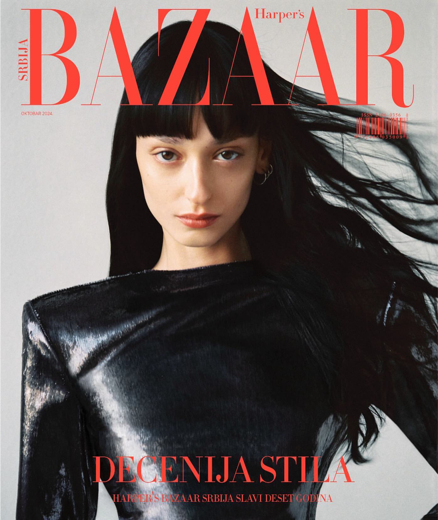 Harper's Bazaar Serbia cover featuring a model with dark hair and bangs wearing a shiny black top. The magazine's title is displayed in bold red letters.