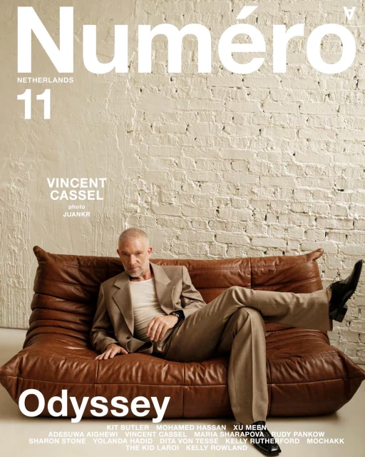 Magazine cover features Vincent Cassel reclining on a brown leather sofa in a beige suit. The cover includes the magazine's title.