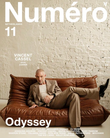 Magazine cover features Vincent Cassel reclining on a brown leather sofa in a beige suit. The cover includes the magazine's title.