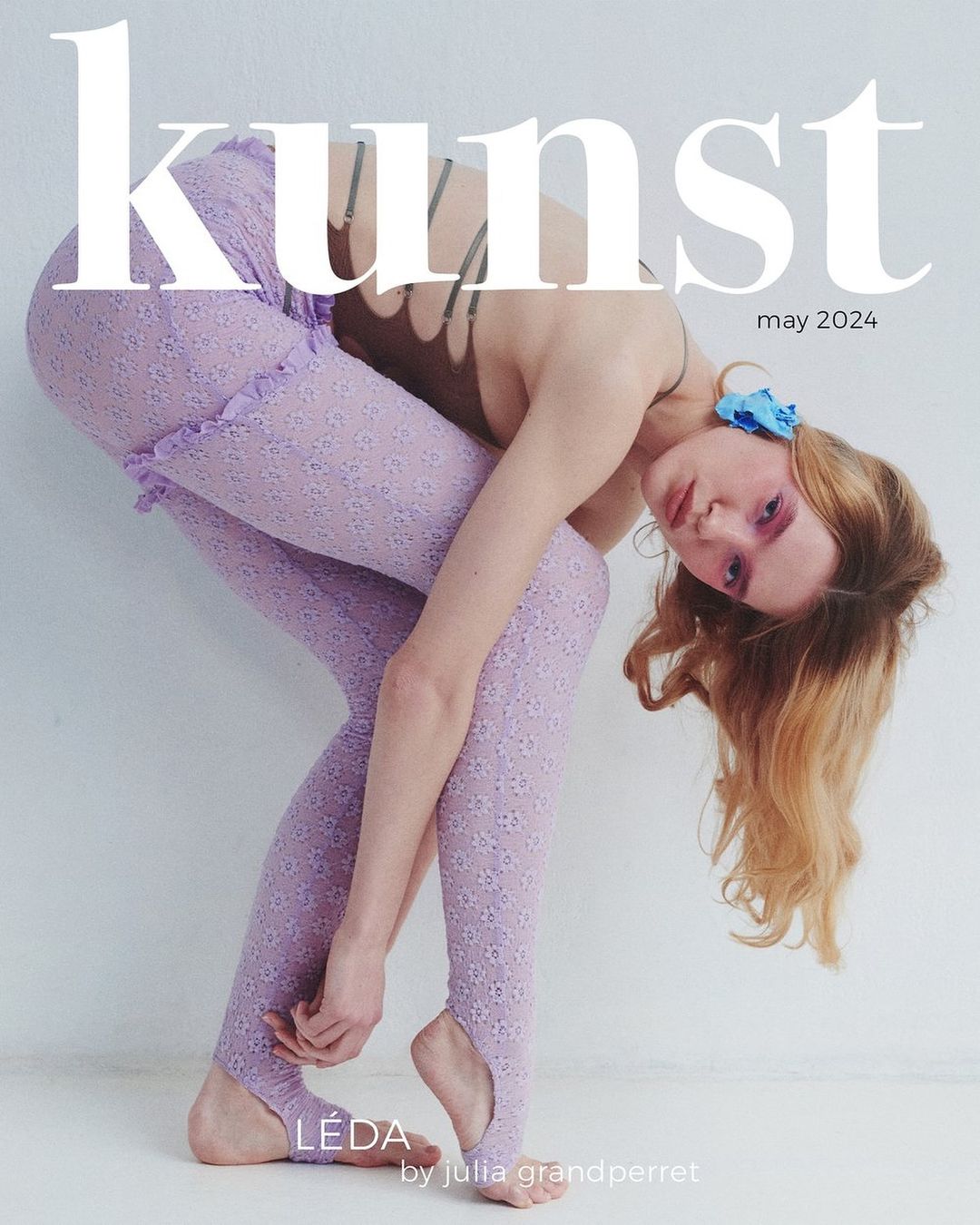 Fashion editorial featuring a woman in lilac lace leggings and a brown top, posing against a white background, with 'Kunst May 2024' text overlay.