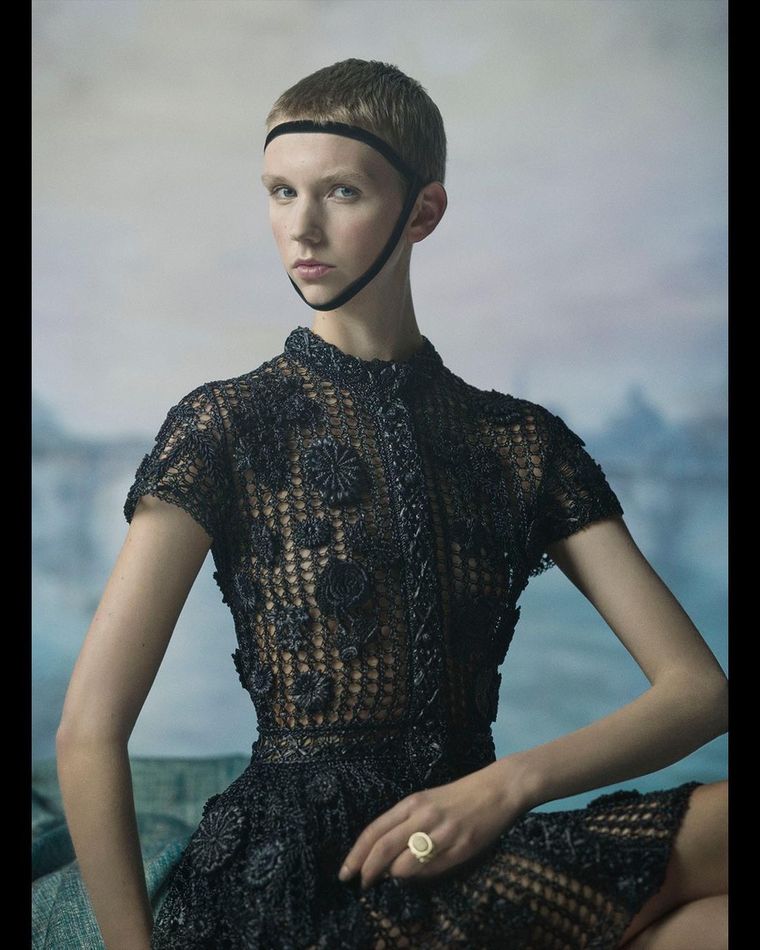 Model with a buzzed haircut wearing a black embellished lace top and headband by photographer Julia Hetta.
