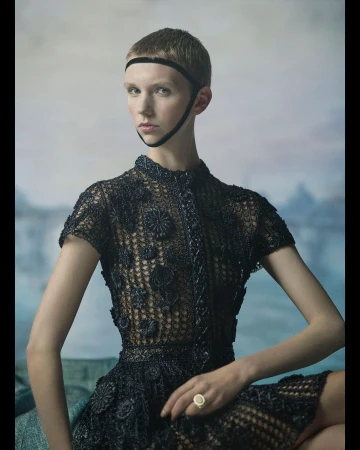 Model with a buzzed haircut wearing a black embellished lace top and headband by photographer Julia Hetta.