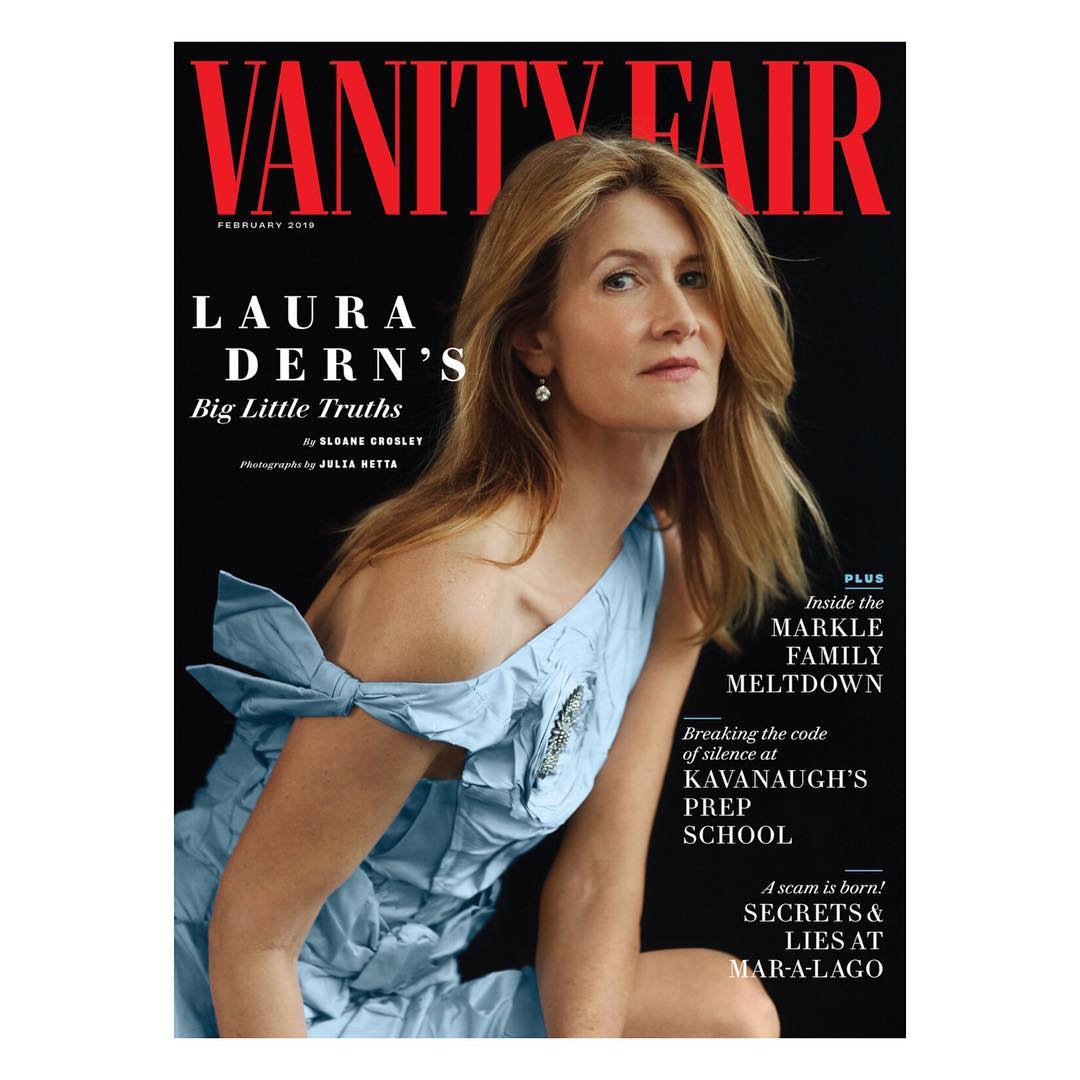 Laura Dern graces the cover of Vanity Fair. She wears a light blue dress with a bow, set against a dark background.