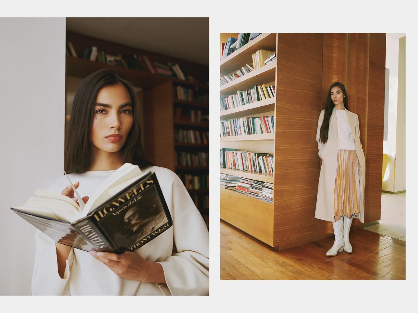 Indoor fashion shot of a woman with long dark hair holding a book, wearing a cream-colored long-sleeve shirt and light makeup, indoors.