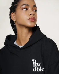 Close-up portrait of a woman wearing a black hoodie with white typography, styled by photographer Julia Sariy in New York