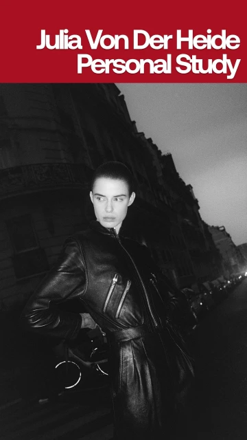 Monochrome portrait of a woman wearing a leather outfit outdoors in an urban setting, showcasing fashion and editorial style.