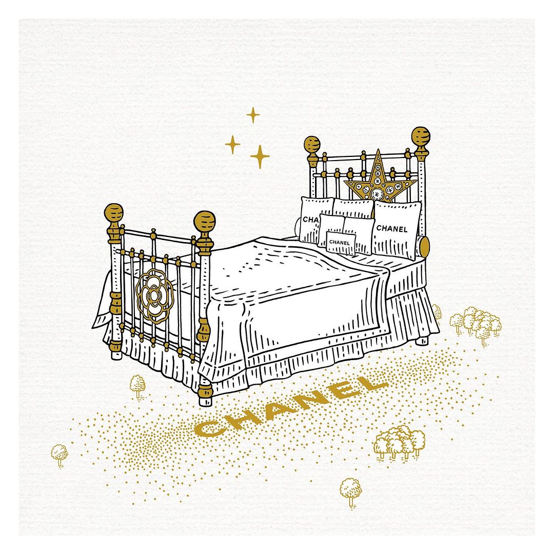 Illustration of a Chanel-branded bed with white bedding, a gold frame, and gold decorative details against a white background.